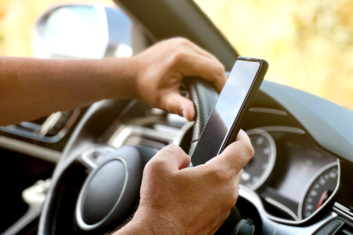 Distracted Driver using a cellphone while driving a car.